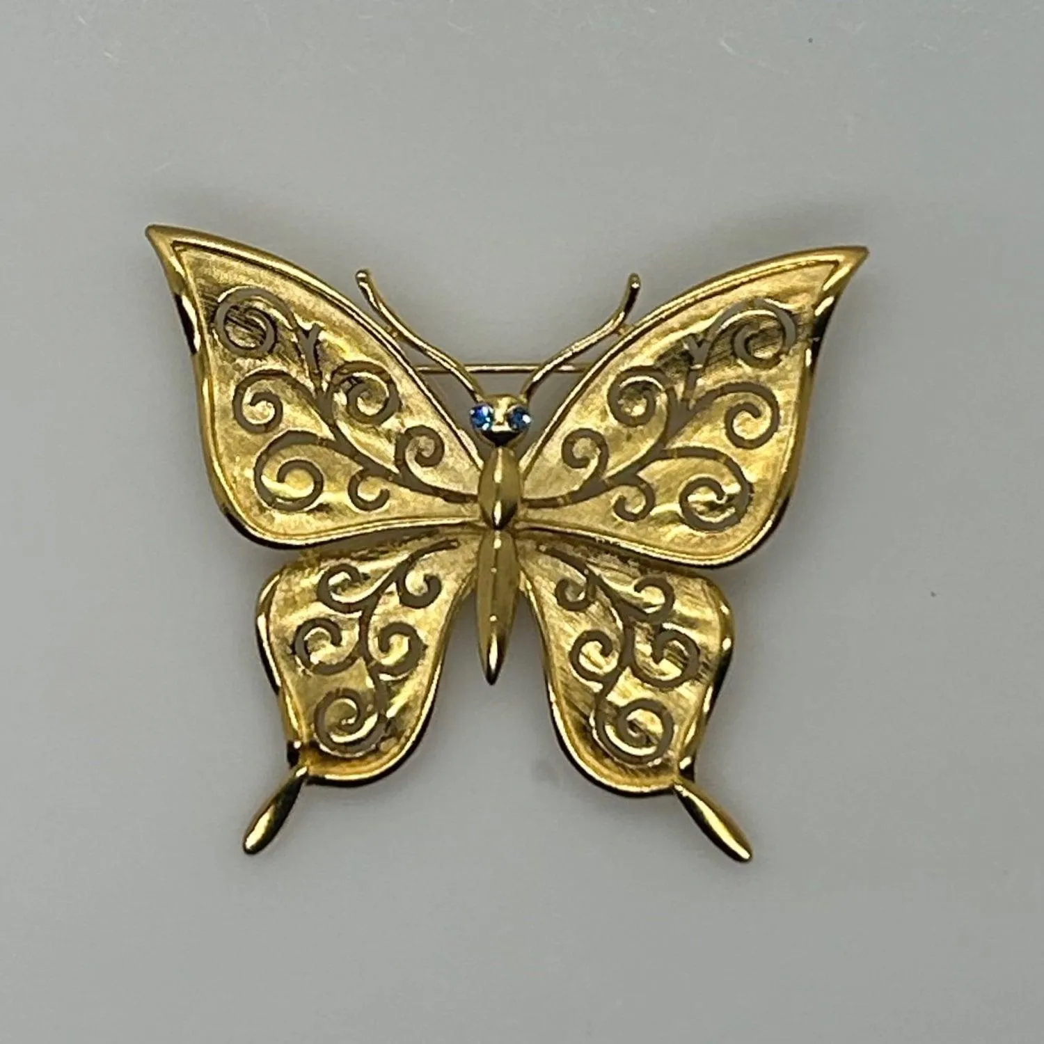 Crown Trifari Gold Tone Filigree Butterfly Brooch with Blue Eyes