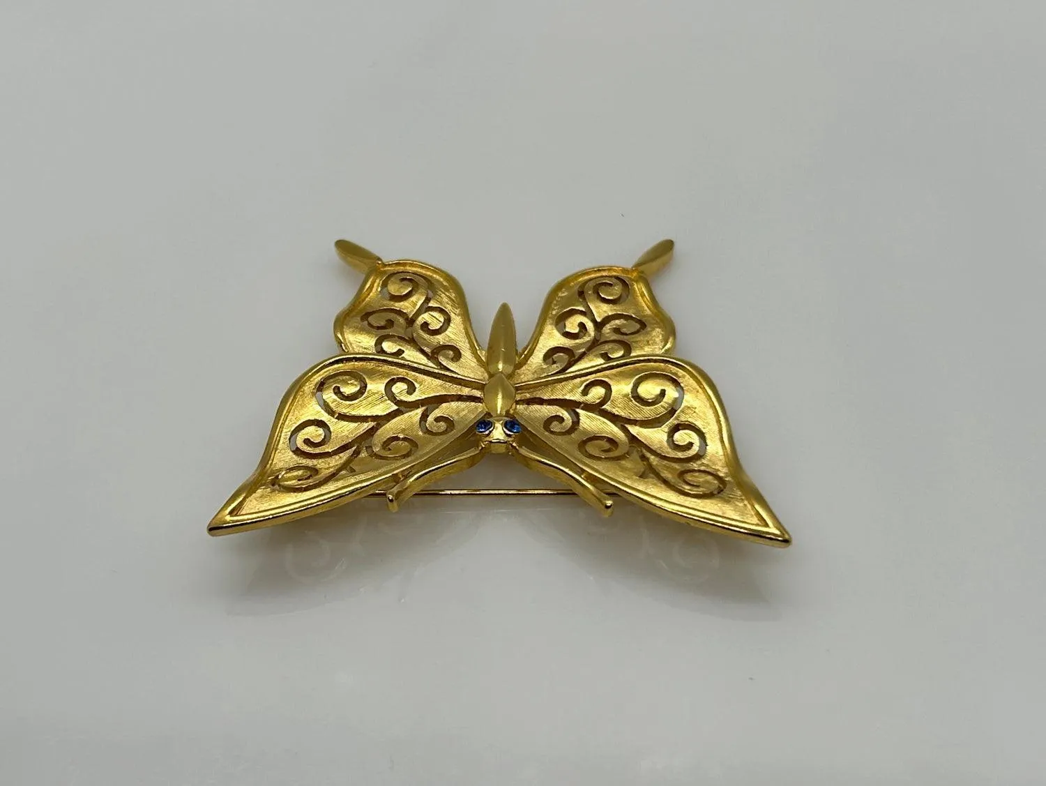 Crown Trifari Gold Tone Filigree Butterfly Brooch with Blue Eyes