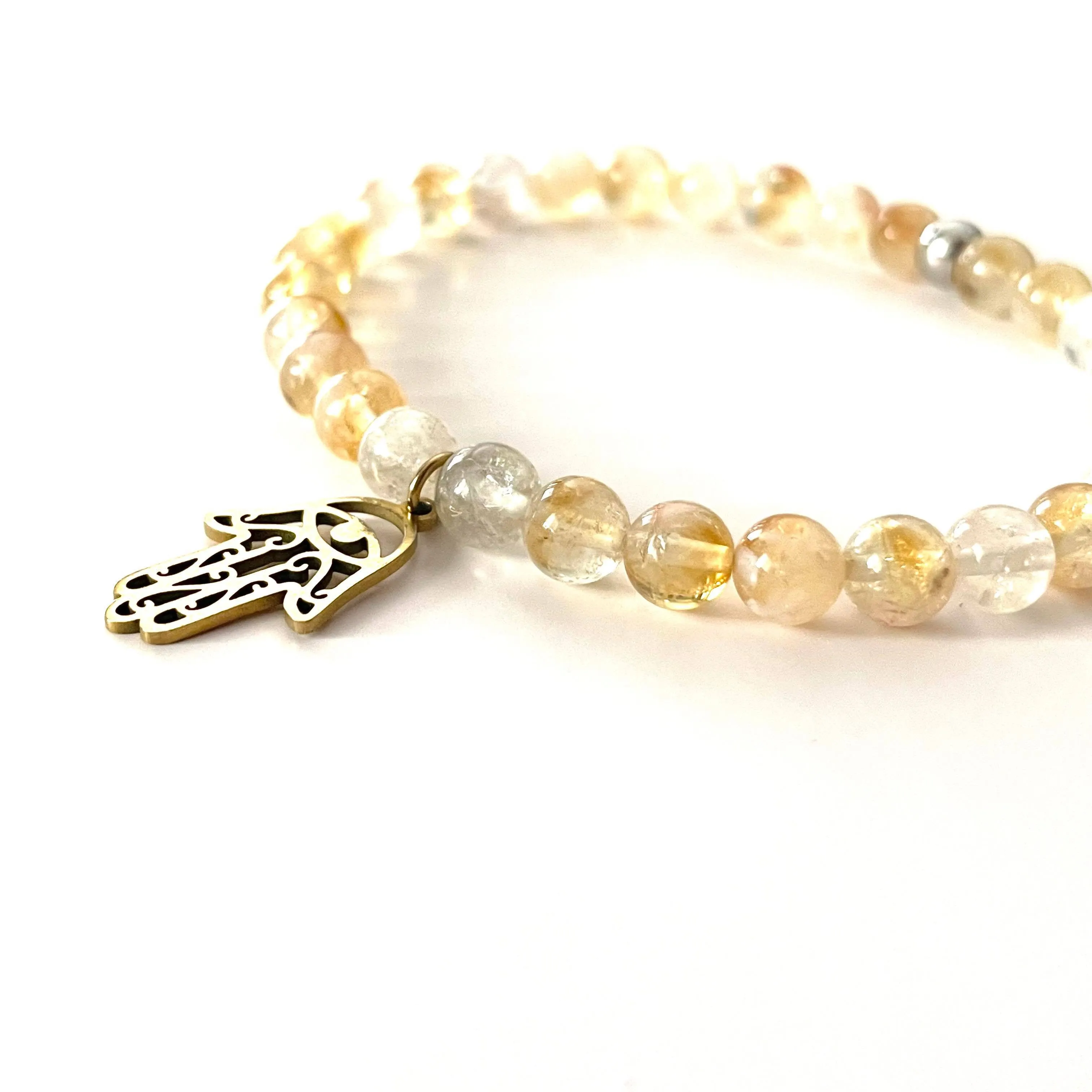 The “Charmed Citrine & Hamsa Hand Mala Bracelet